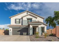 Charming two-story home with a well-manicured front yard, neutral tones, and a two car garage at 38659 N Alamo Ct, San Tan Valley, AZ 85140