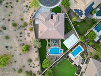 Stunning aerial view of an estate home showcasing a pool, sport court, patio, and lush landscaping at 4417 W El Cortez Trl, Phoenix, AZ 85083