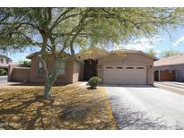 Charming single-story home features a well-maintained front yard, mature landscaping, and a two-car garage at 7151 W Lamar Rd, Glendale, AZ 85303