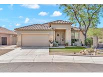 Charming home featuring a tile roof, desert landscaping, and a two-car garage at 8465 W Andrea Dr, Peoria, AZ 85383