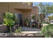Inviting front entrance featuring mature plants and a well-designed doorway at 9543 E Kiisa Dr, Scottsdale, AZ 85262