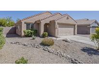 Charming single-story home featuring desert landscaping and a tile roof at 15962 W Gibson Ln, Goodyear, AZ 85338