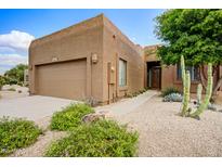 Charming single-story home with desert landscaping, a two-car garage, and inviting entryway at 19115 E Buckskin Ct, Rio Verde, AZ 85263