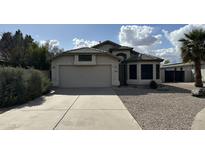 Charming single-story home with a well-maintained front yard and a two-car garage at 19976 N 63Rd Dr, Glendale, AZ 85308