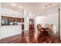 Open-concept space with hardwood flooring, modern kitchen, and elegant dining area at 20801 N 90Th Pl # 210, Scottsdale, AZ 85255