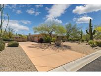 Expansive front yard featuring desert landscaping, mature trees, and a circular driveway at 22469 N 79Th Pl, Scottsdale, AZ 85255