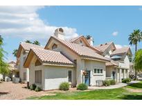 Charming home with a red tile roof, manicured lawn, and inviting blue front door at 2801 N Litchfield Rd # 37, Goodyear, AZ 85395