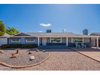 Charming single-story home with a well-maintained yard, blue exterior, and desert landscaping at 3109 N 81St St, Scottsdale, AZ 85251