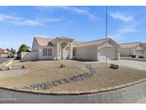 Charming single-story home with a well-maintained yard, decorative rock landscaping and a two car garage at 5046 W Monte Cristo Ave, Glendale, AZ 85306