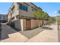 Townhome exterior with private entry and xeriscape landscaping with gated front patio area at 7464 E Paraiso Dr, Scottsdale, AZ 85255