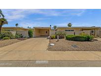 Inviting single-story home featuring a carport and low-maintenance desert landscaping at 9707 W Lancaster Dr, Sun City, AZ 85351