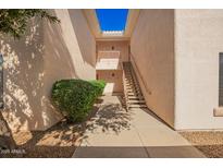 Condo exterior with a stairway and greenery at 10030 W Indian School Rd # 165, Phoenix, AZ 85037