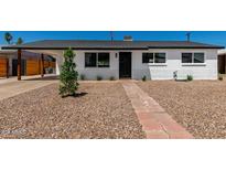 Charming single-story home featuring a landscaped front yard and a welcoming brick pathway at 1308 N 71St St, Scottsdale, AZ 85257