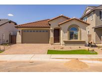 Charming single-story home with a red tile roof, two-car garage, and low maintenance desert landscaping at 15796 W Georgia W Dr, Surprise, AZ 85379