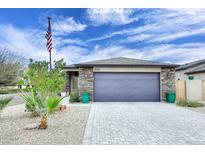 Beautiful single-story home with a two-car garage, stone accents, desert landscaping and American flag at 16705 E Almont Dr # A, Fountain Hills, AZ 85268