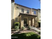 Charming two-story townhouse with a covered porch and well-maintained landscaping at 21166 W Main St, Buckeye, AZ 85396