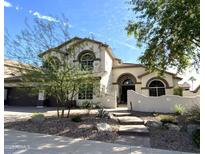Charming two-story home featuring a desert landscaped front yard and a welcoming entrance at 3166 E Desert Willow Rd, Phoenix, AZ 85048