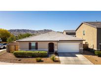 Charming single-story home featuring a two-car garage, desert landscaping, and a beautiful mountain view at 3319 W Carter Rd, Phoenix, AZ 85041