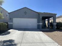 Charming single-story home with a two-car garage, covered porch and desert landscaping at 3602 N 300Th Dr, Buckeye, AZ 85396