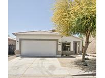 Charming single-story home featuring a two-car garage and a well-maintained front yard with mature tree at 365 E Mountain View Rd, San Tan Valley, AZ 85143
