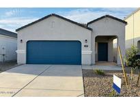 Charming single-story home with a blue garage door and well-maintained front yard at 5094 E Umber Rd, San Tan Valley, AZ 85143