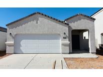 Charming single-story home featuring a bright white exterior, attached two-car garage, and covered porch at 5094 E Umber Rd, San Tan Valley, AZ 85143