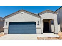 Charming single-story home featuring a blue garage door and a welcoming front entry, set against a clear blue sky at 5094 E Umber Rd, San Tan Valley, AZ 85143