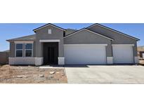 Charming single-story home featuring a two-car garage and neutral-colored stucco exterior under a clear, blue sky at 5865 E Axle Ln, San Tan Valley, AZ 85140