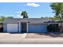 Charming single-story home featuring a well-maintained yard, fresh paint, and an attached one car garage at 7635 E Verde Ln, Scottsdale, AZ 85251