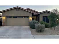 Charming single-Gathering home featuring a two-car garage and well-manicured landscaping at 13783 W Caribbean Ln, Surprise, AZ 85379