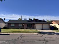 Charming single-story home featuring a two-car garage and well-maintained front lawn at 1923 E Huntington Dr, Tempe, AZ 85282