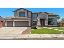 Beautiful two-story home showcasing a three-car garage, and well-maintained landscaping at 2036 S Reseda Ct, Gilbert, AZ 85295