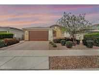 Inviting single-story home with a brown garage door, desert landscaping, and charming curb appeal at 22560 E Rosa Rd, Queen Creek, AZ 85142