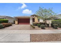 Charming single-story home with a two-car garage, desert landscaping, and a welcoming front entrance at 22560 E Rosa Rd, Queen Creek, AZ 85142