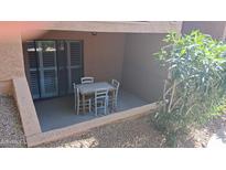 Covered patio with tiled table and chairs, offering an outdoor dining space at 3031 N Civic Center Plz # 113, Scottsdale, AZ 85251