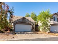 Home exterior featuring an attached two-car garage with an arched entryway and a concrete driveway at 3755 E Broadway Rd # 36, Mesa, AZ 85206