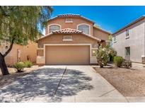 Charming two-story home with a well-maintained front yard and a two-car garage, featuring desert landscaping at 4034 E Mine Shaft Rd, San Tan Valley, AZ 85143