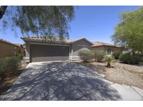 Charming single-story home featuring a two-car garage and low maintenance desert landscaping at 41388 W Hopper Dr, Maricopa, AZ 85138