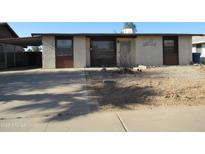 Modest one-story home with desert landscaping, covered parking and stucco exterior at 430 W Santa Cruz Dr, Tempe, AZ 85282