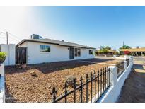 Well-kept single-story home featuring a low-maintenance, xeriscaped front yard and secure fence at 4750 N 50Th Ave, Phoenix, AZ 85031