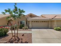 Charming single-story home featuring a tile roof, desert landscaping, and a two-car garage at 5830 E Mckellips Rd # 2, Mesa, AZ 85215