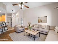 Inviting living room with vaulted ceilings, plush seating, and a stylish coffee table creates a warm and welcoming space at 5830 E Mckellips Rd # 2, Mesa, AZ 85215