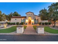 Inviting single-story home with manicured landscaping and a charming brick pathway leading to the front entrance at 7425 W Caro Rd, Glendale, AZ 85308