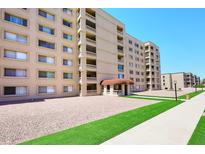 Attractive condo building with well-kept landscaping and a welcoming entrance area on a sunny day at 7950 E Camelback Rd # 308, Scottsdale, AZ 85251