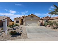 Inviting single-story home with a well-maintained desert landscape and a two-car garage at 10832 W Piute Ave, Peoria, AZ 85373