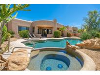 Inviting backyard oasis featuring a sparkling pool and hot tub, perfect for relaxation and entertaining at 10901 E Quarry E Trl, Scottsdale, AZ 85262