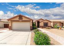 Charming single-story home featuring a two-car garage, desert landscaping, and a tiled roof at 11133 E Dragoon Ave, Mesa, AZ 85208