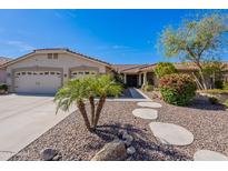 Charming single-story home featuring a manicured front yard, a two-car garage, and a welcoming entrance at 13305 W Colter St, Litchfield Park, AZ 85340