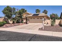 Charming home featuring a two-car garage, desert landscaping, and a welcoming facade at 14680 W Morning Star Trl, Surprise, AZ 85374