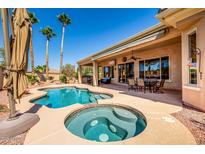 Inviting pool and spa with swaying palm trees create a serene backyard oasis for relaxation and entertainment at 22318 N Pico Ct, Sun City West, AZ 85375